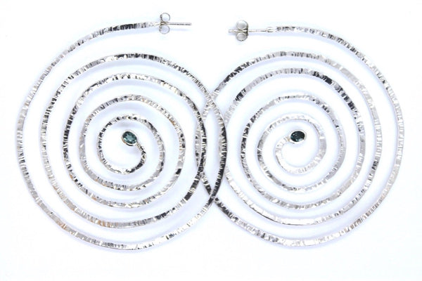 Spiral silver earrings with oval green tourmalines set at their centre