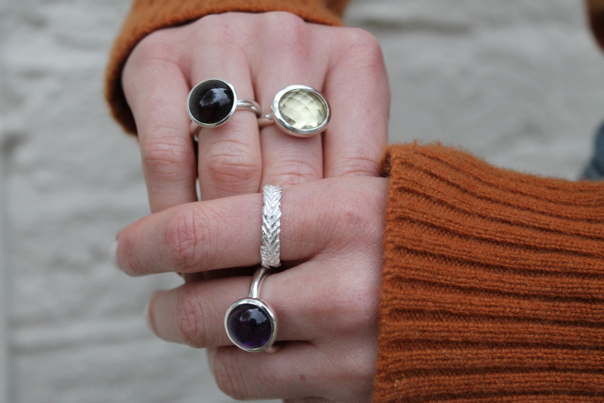 checkerboard cut 16x12 citrine silver. Garnet cabochon ring. Amethyst cabochon ring. Silver leaf band. Shown worn  together on hands