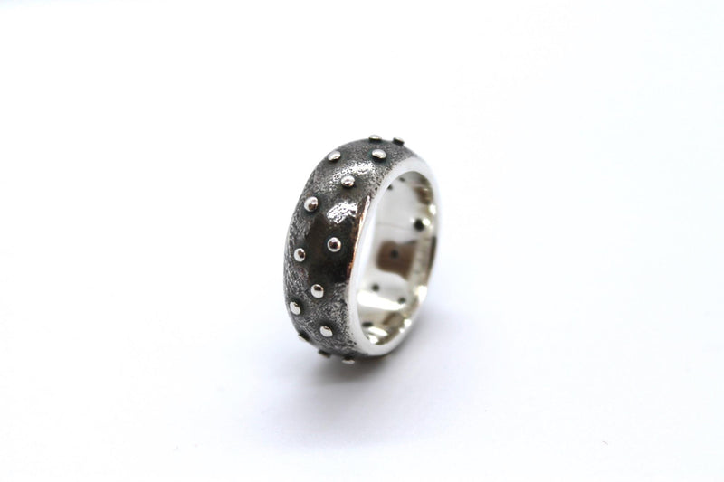 heavyweight d shaped wide silver band, matt and blackened silver textured with shiny pinheads. 