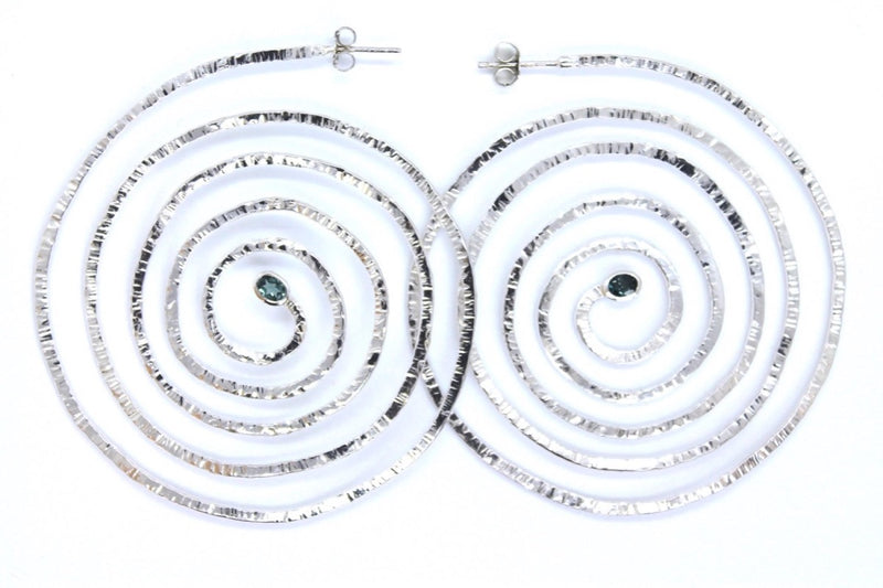 Spiral silver earrings with oval green tourmalines set at their centre
