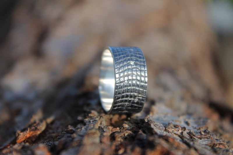 Crocodile textured wide silver band ring blackened with 9 tiny  diamonds contrasting against the dark silver
