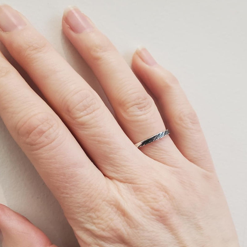 3mm artisanal silver band with black oxidised river imprinted into band