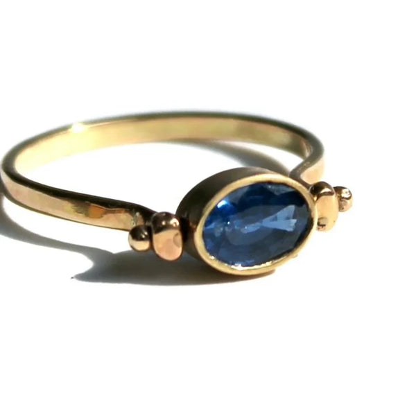 Sapphire and gold swivel ring