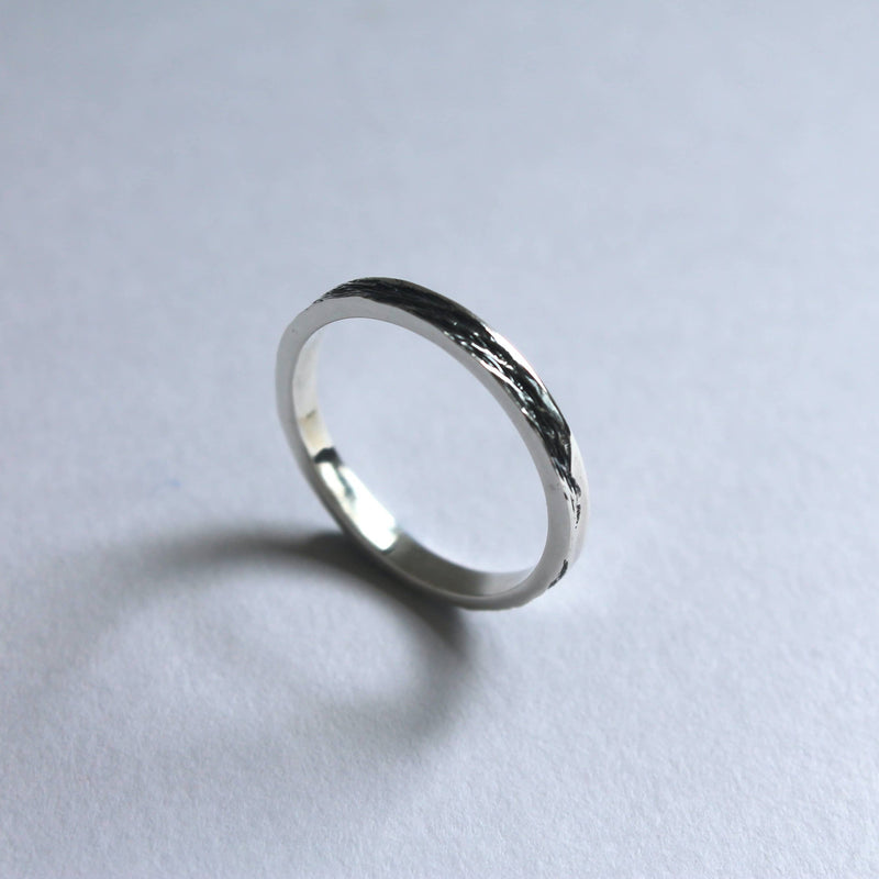 silver 3mm artisanal band with black river imprinted
