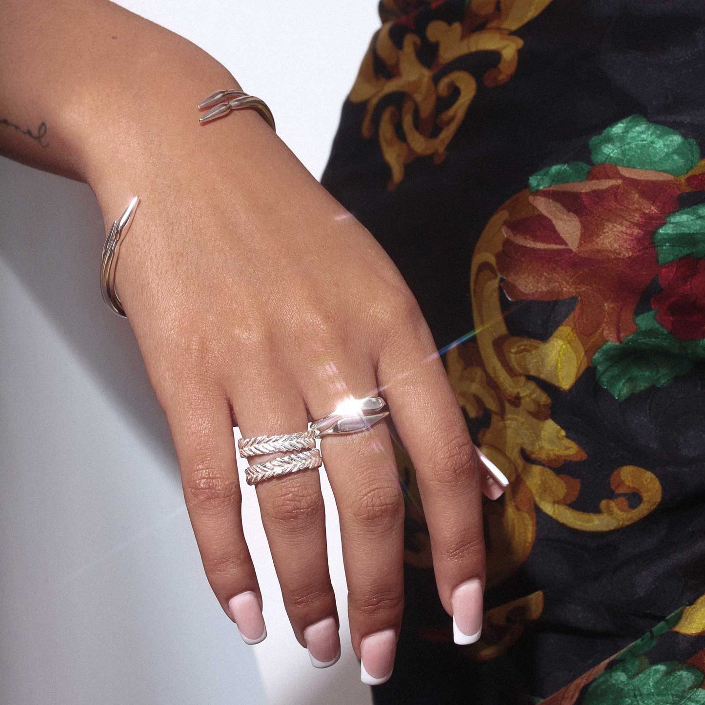 silver arrowhead bangles and 3 silver rings